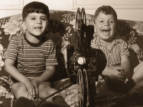 two-boys-watching-a-home-movie-using-an-old-projector_i-G-56-5653-43OMG00Z
